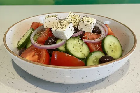 Greek Salad: tomato, onion, cucumber, olives, goat cheese, oregano and citrus dressing